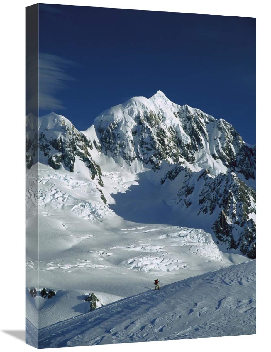 Ski mountaineer near summit with Mt Tasman behind, Westland NP, New Zealand-Canvas Art-16x24”